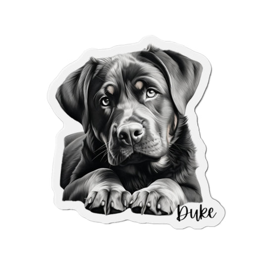 "A Rottweiler dog magnet portraying a robust and attentive Rottweiler sitting regally. Its rich black and tan coat gleams against a muted gray background, highlighting the dog’s strong build and loyal gaze. This magnet adds a noble and protective vibe to any collection."